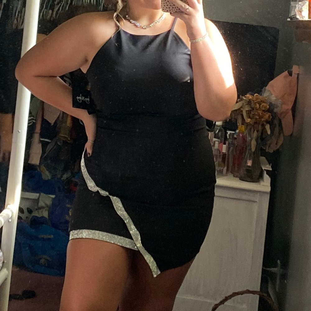 Black formal dress with silver cross over band.